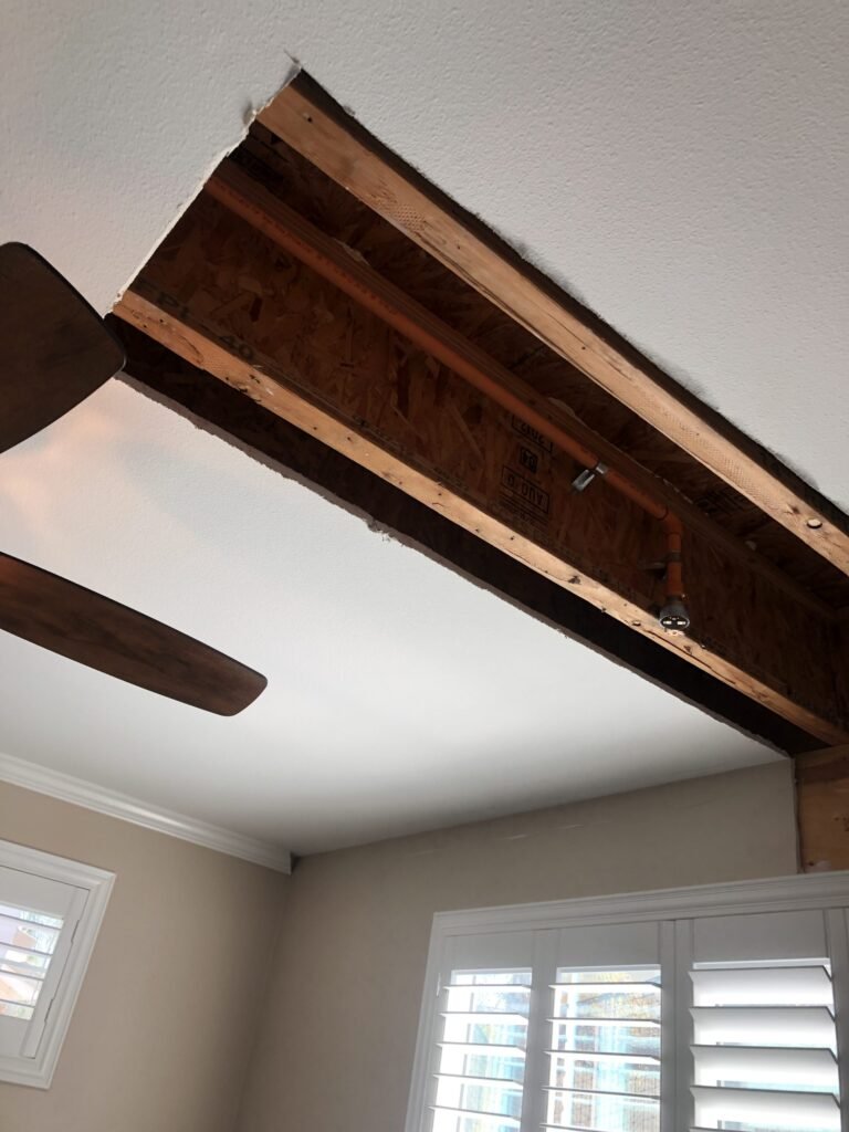 Ceiling opened to exposed joists above a living room — Fillmore