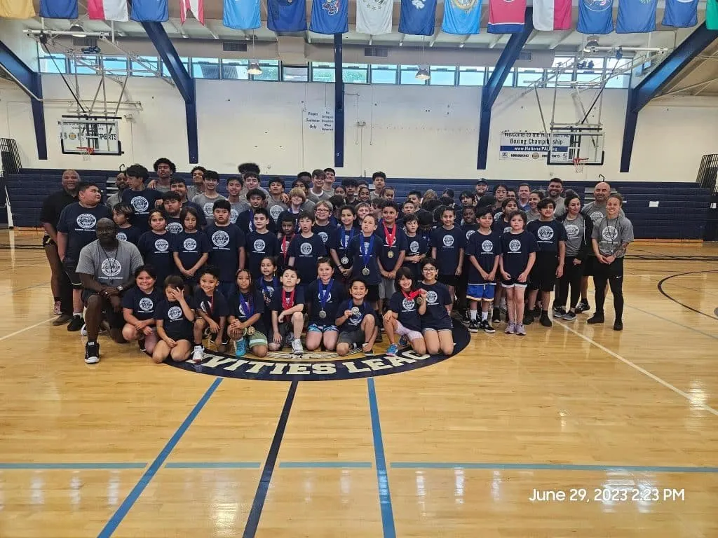 Large group photo of a youth basketball camp in a gym