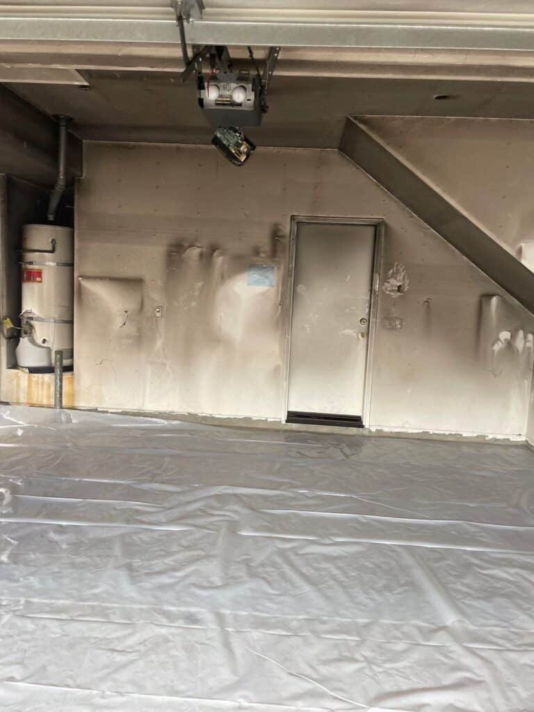 Dark smoke residue above garage cabinets