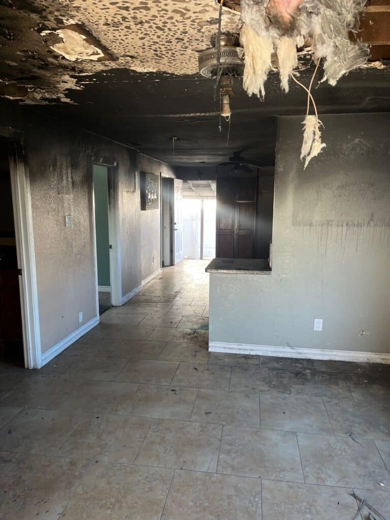 Fire damage and dark residue across a room's ceiling and walls — Santa Paula