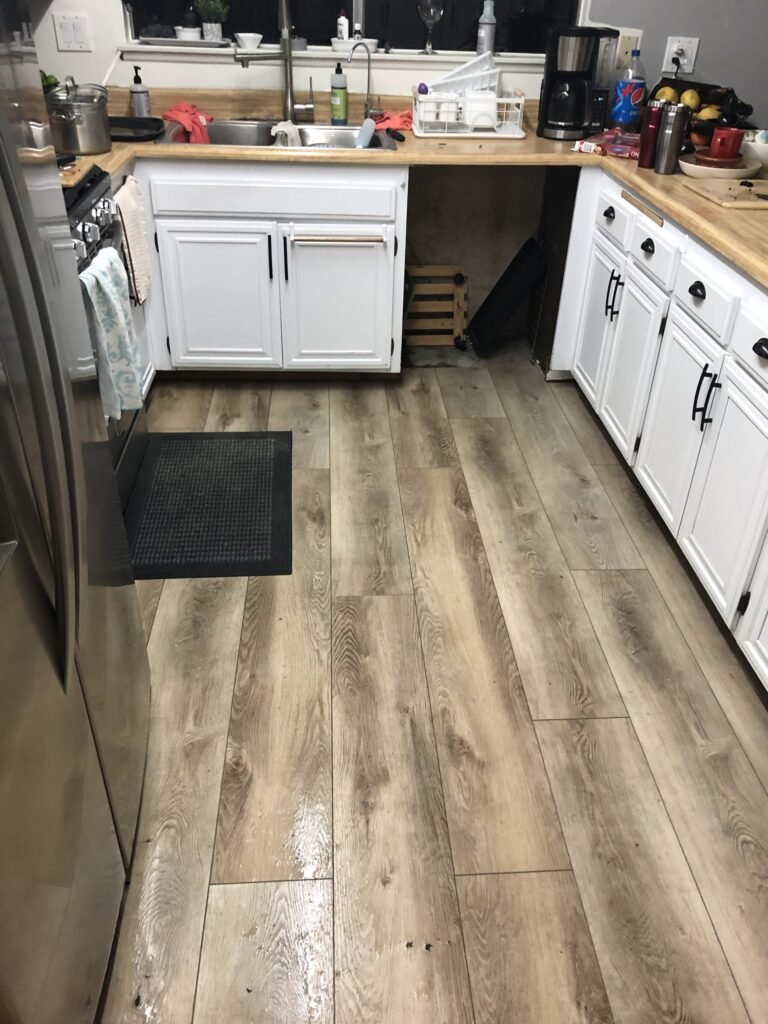 Kitchen flooring and cabinets shown during the project inspection