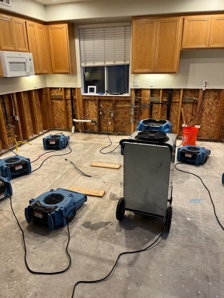 Drying equipment in a kitchen with lower cabinets and wall materials removed