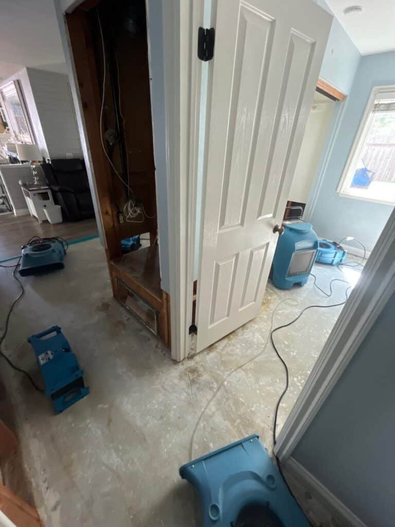 Drying equipment in adjoining rooms beside exposed lower walls