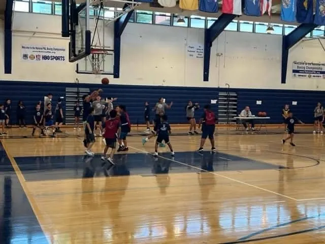 Youth basketball players practicing in a gym