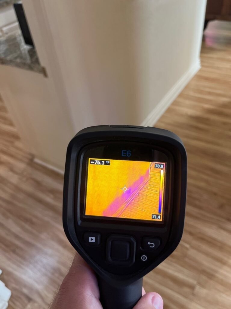 Thermal imaging camera checking an interior wall area