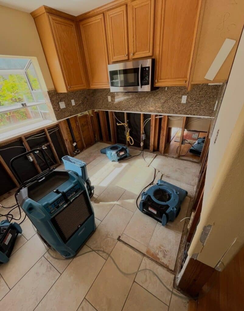 Kitchen drying equipment beside exposed lower wall framing