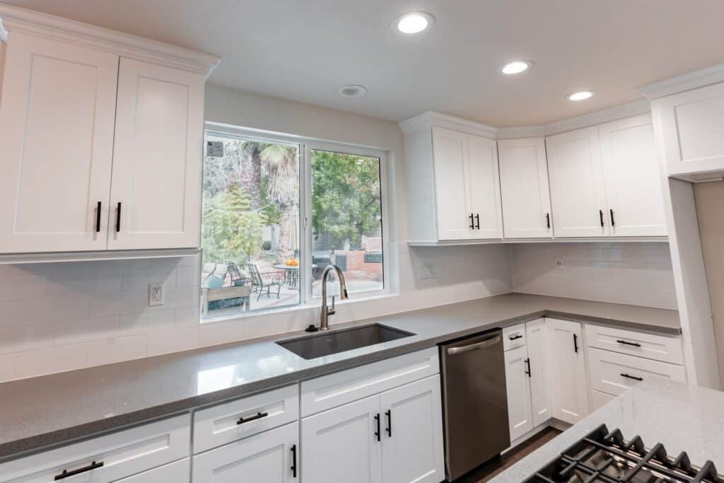 White kitchen cabinets, countertop and sink in a project gallery