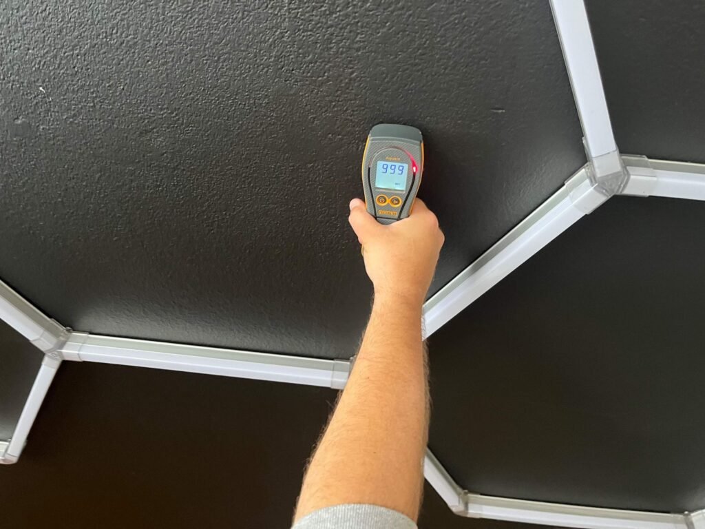 Moisture reading during an upstairs bathtub overflow project in Port Hueneme