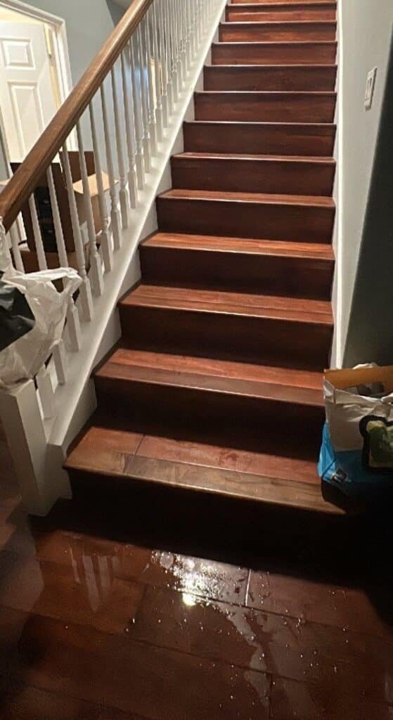 Stairway and wood flooring shown during a water damage project