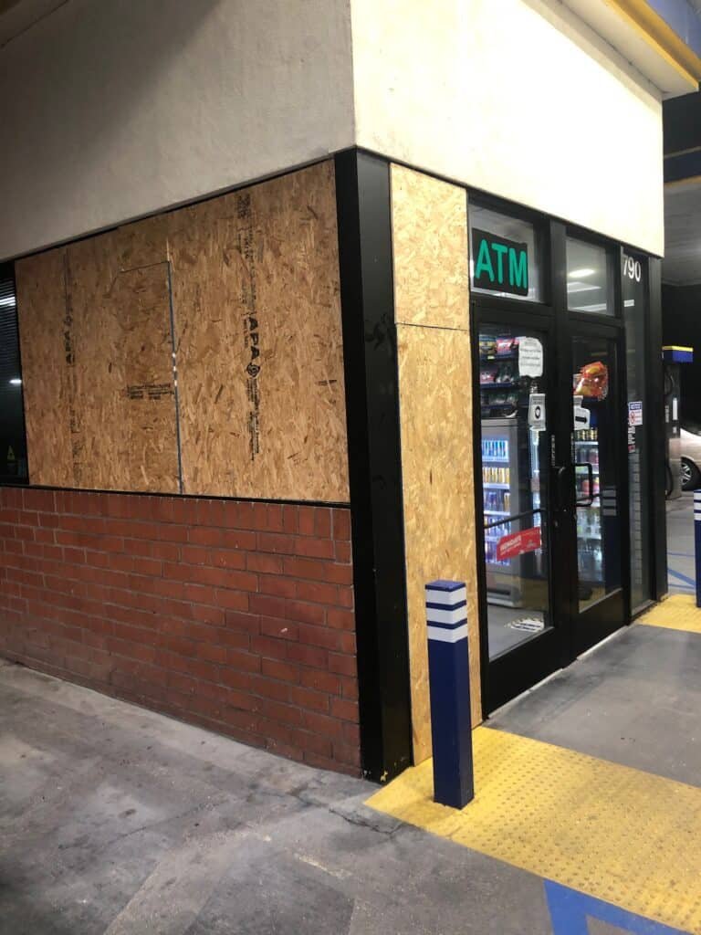 Plywood protecting a damaged storefront opening — Oxnard