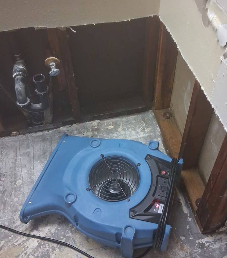 Air mover directed toward an opened bathroom wall area