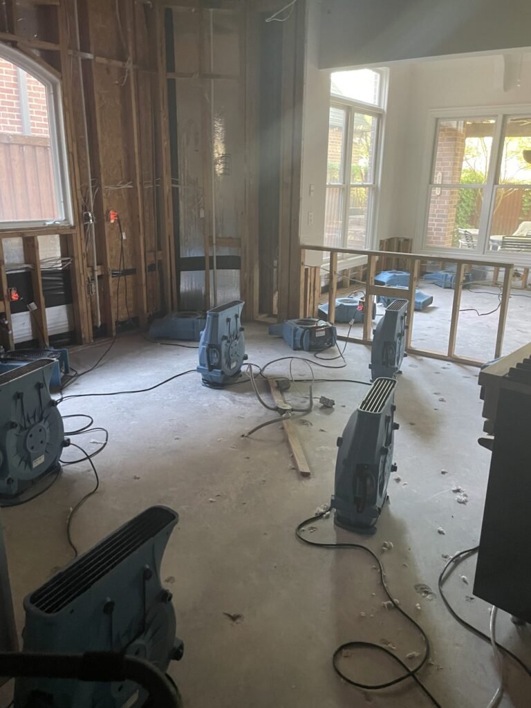 Drying equipment throughout a room with lower wall materials removed