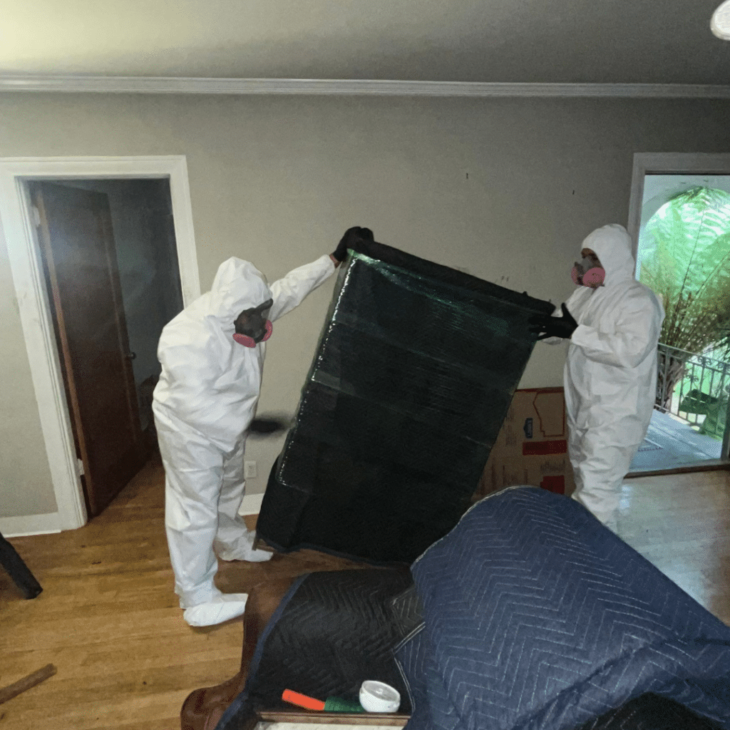 JW Home Care crew handling protected belongings during a pack-out