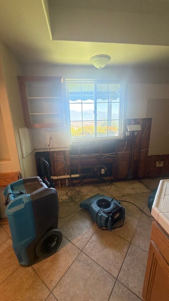 Drying equipment beside exposed kitchen wall framing