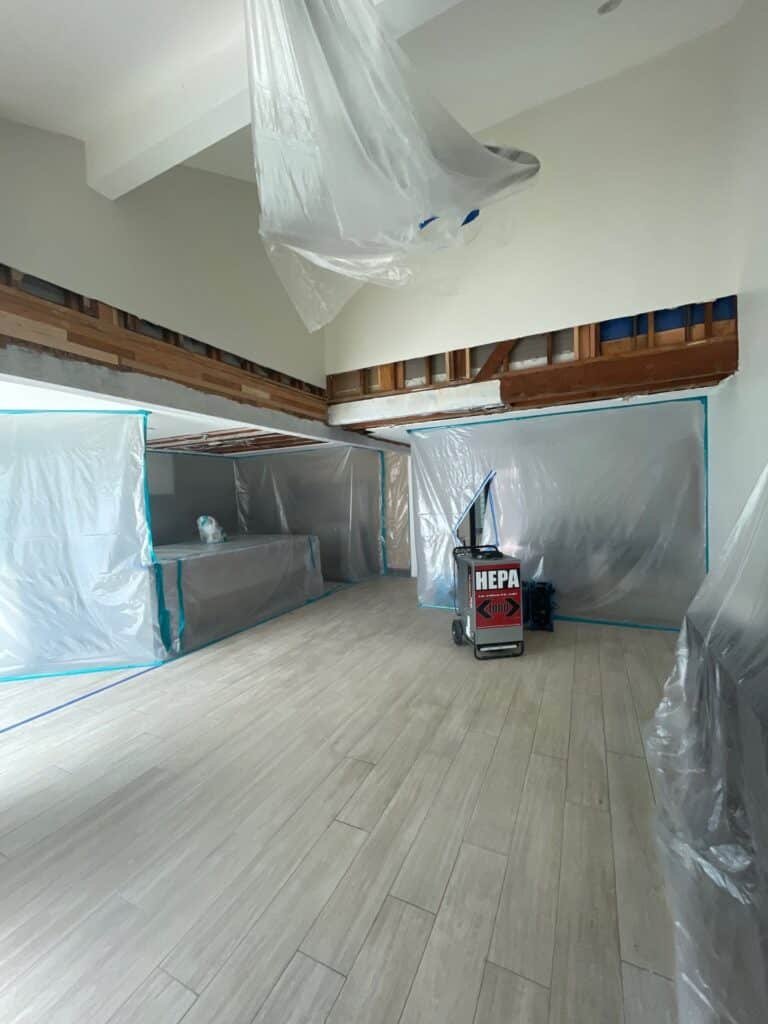 Plastic containment and drying equipment beneath an opened ceiling area