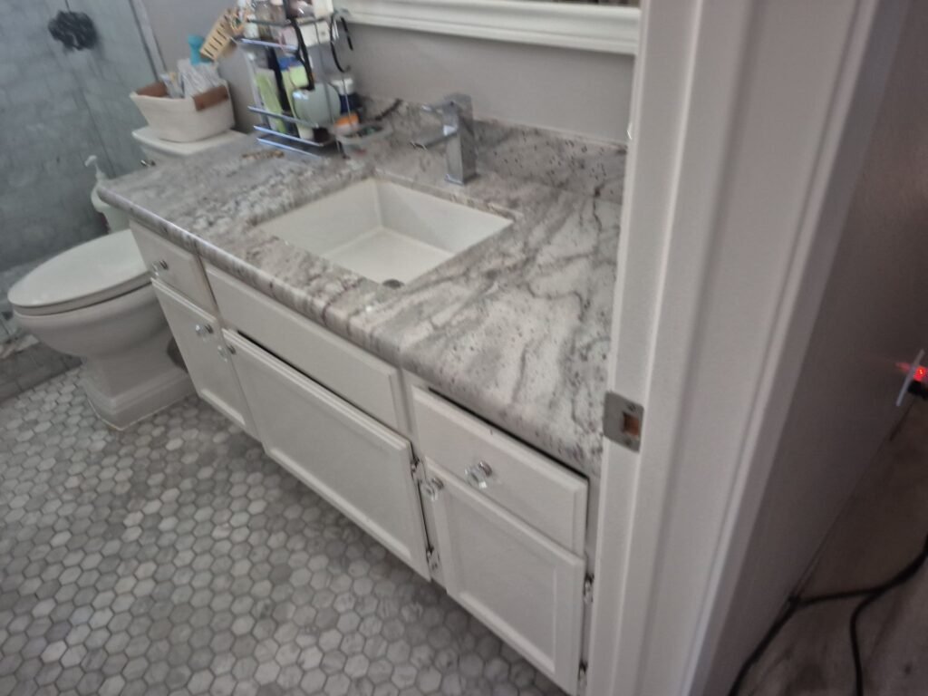 Bathroom vanity and tile flooring shown in the project inspection photos