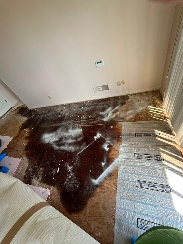 Bedroom flooring removed to expose the affected subfloor